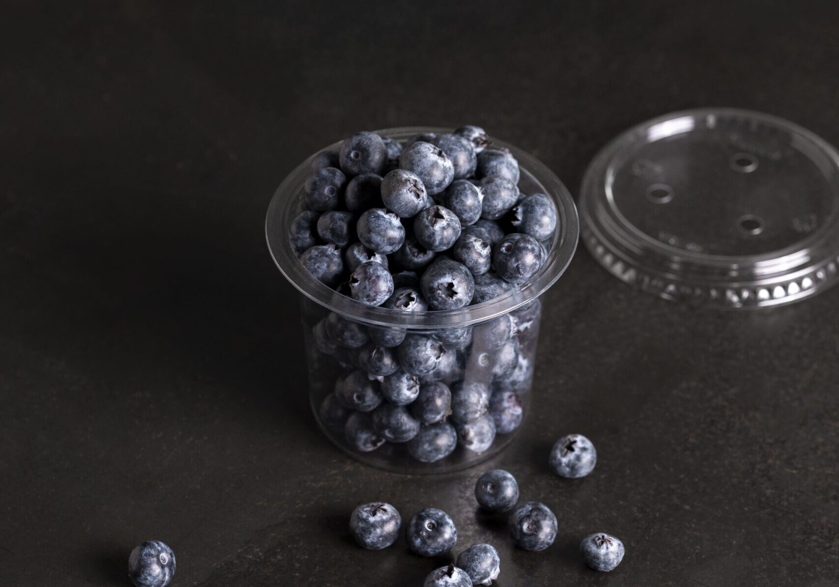 Round plastic PET tub and lid with blueberries.