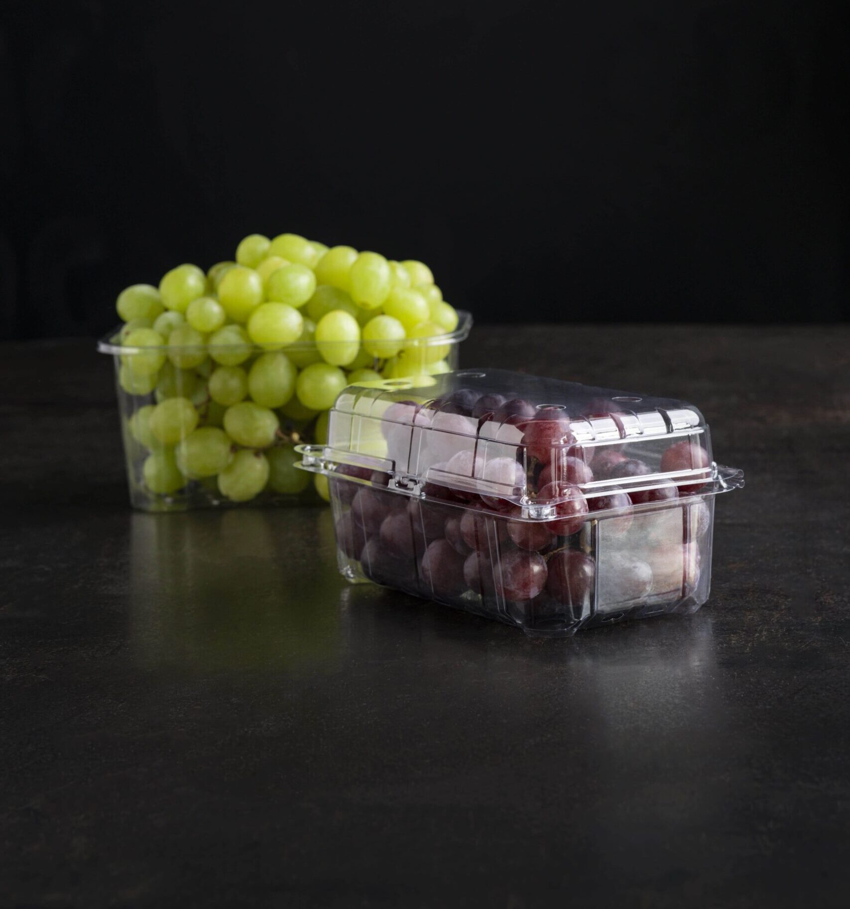 Yucca Packaging medium sized punnet clamshell and a tub without lid filled with red and green grapes.