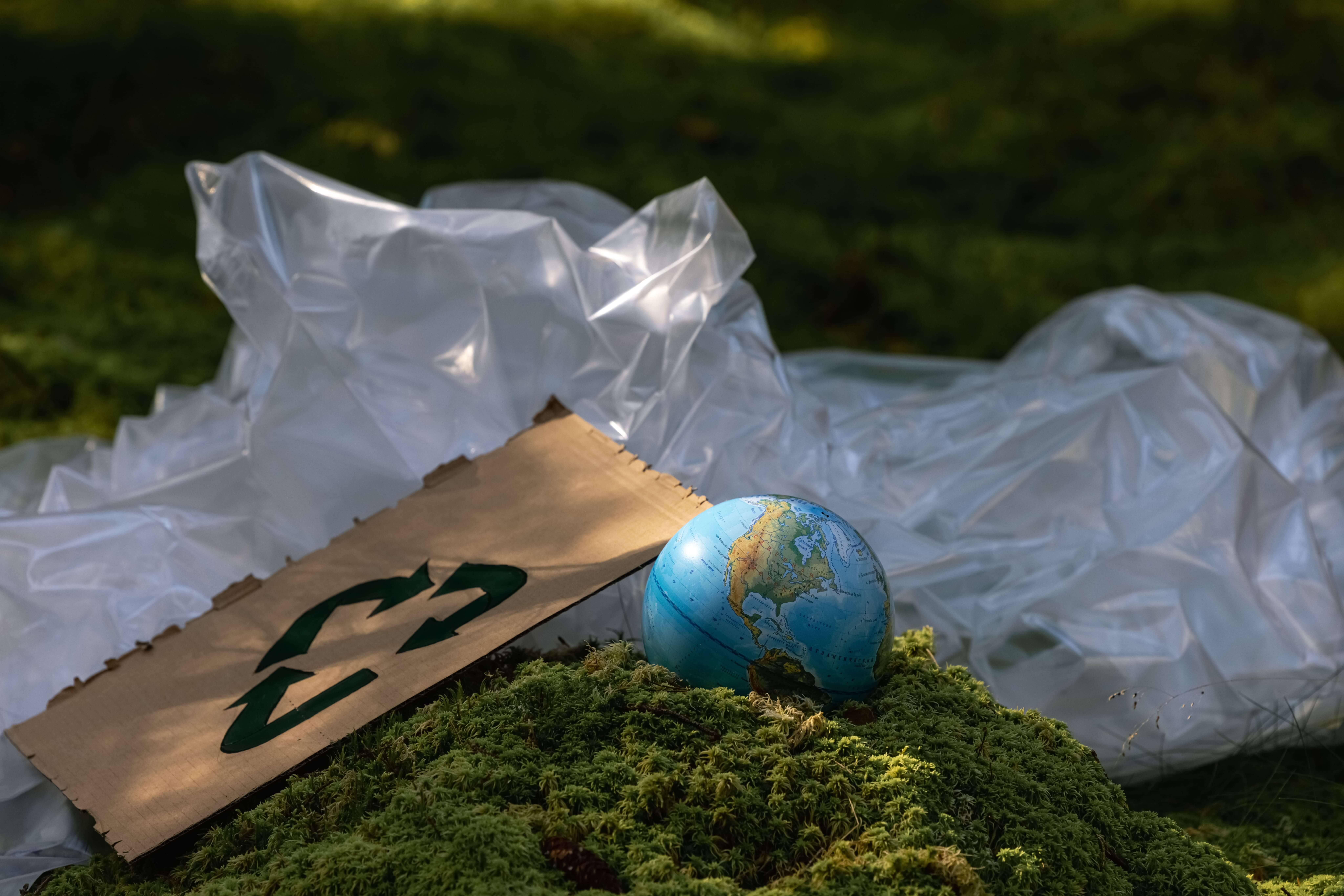 The earth sinking into the ground, with materials staying above the ground, communicating greenwashing in packaging advertising.